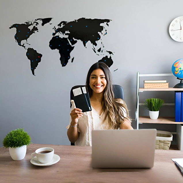 Smiling woman holding passport at desk for migration consultants in Kochi